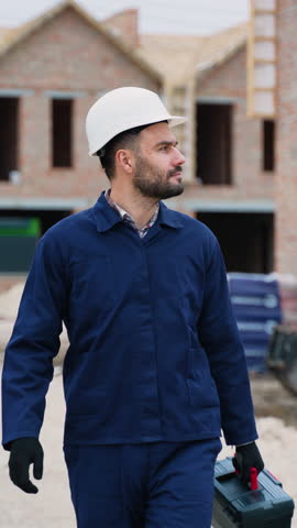 Construction worker inspecting residential building site