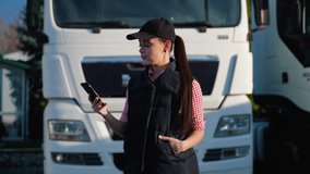 Female truck driver managing tasks via phone on parking - Powered by Shutterstock - Get 15% off with code: PIKWIZARD15