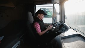 Female truck driver checks route on GPS navigator in cabin - Powered by Shutterstock - Get 15% off with code: PIKWIZARD15
