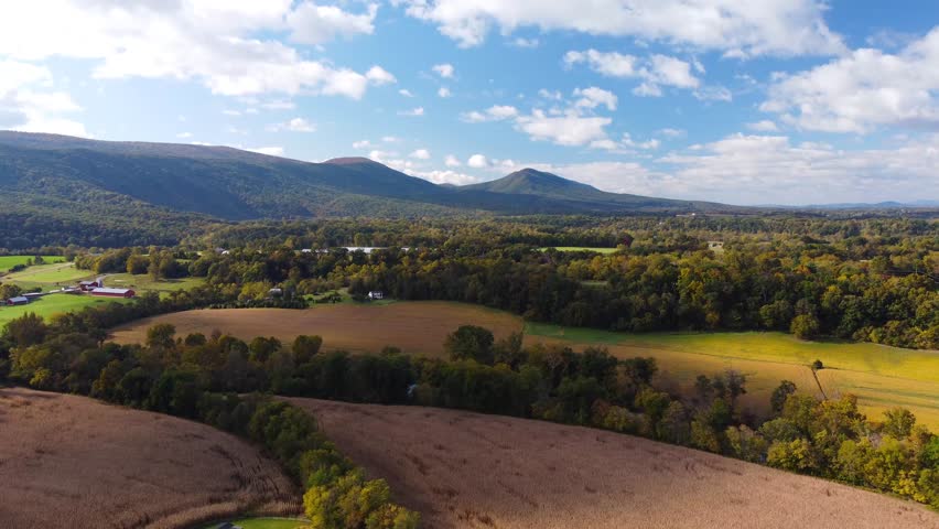 Rural Shenandoah Valley Virginia farmland surrounded by the Shenandoah Mountains during autumn. 4k Aerial View.