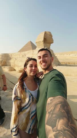 Happy couple taking selfie with great sphinx of giza