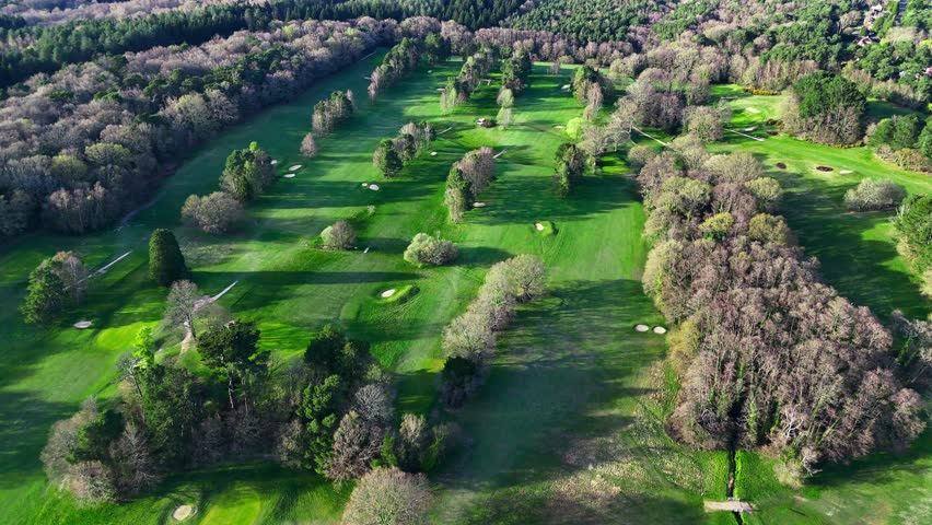 Massive Golf Course Fly Over Surrounded By Forest In Spring Panning Left