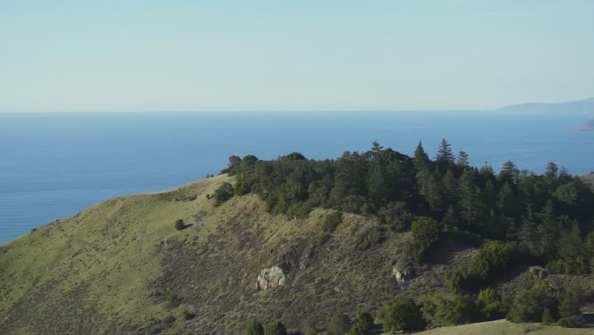 drone shot revealing mountains and forest in big sur, california