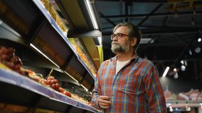 Senior man shopping for lettuce and cabbage in grocery store - Powered by Shutterstock - Get 15% off with code: PIKWIZARD15