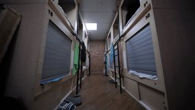 Capsule beds with towels hanging in a hostel dormitory room - Powered by Shutterstock - Get 15% off with code: PIKWIZARD15