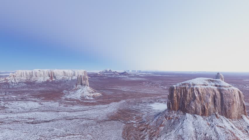 3D - Circular aerial drone view of the snow on Sandstone Buttes in Monument Valley Navajo Tribal Park on the Colorado Plateau. Arizona. United States