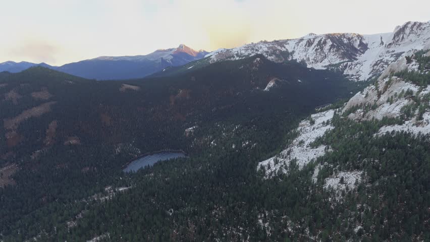 3D - Side aerial drone shot of the snow in Rocky Mountain National Park. Colorado. United States