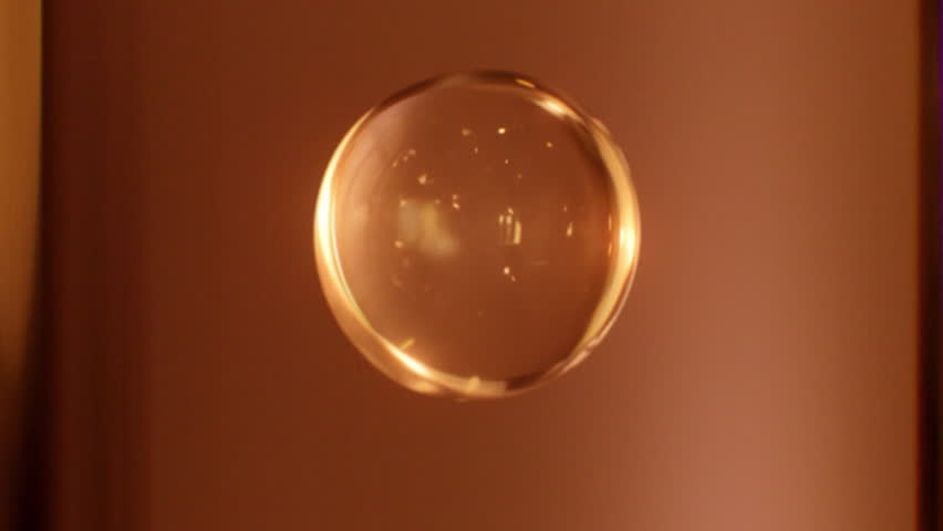 Gold essence ball falling down, activating cells to penetrate the skin, cosmetic essence ball molecules for cream, face serum, hair care, essential oil. 3d animation.