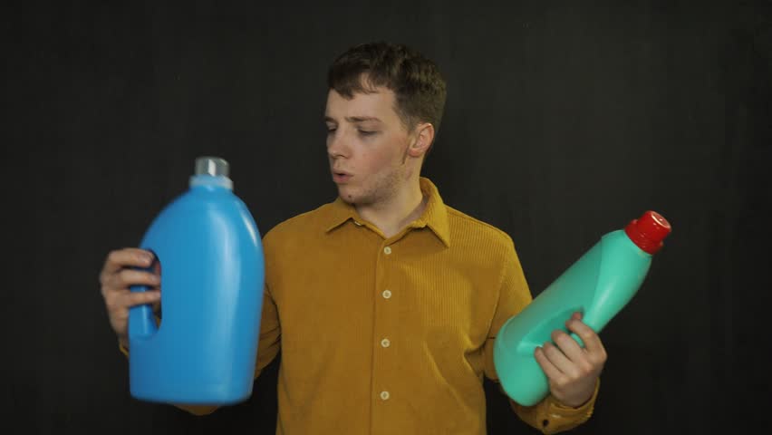 A man chooses a cleaning product for the premises.