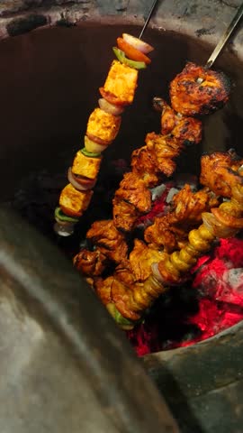 Cooking Paneer, Chicken Roti on Skewers in a Traditional Tandoor in Delhi.