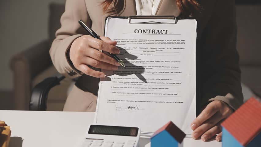 Real estate agent and customer signing contract to buy house, insurance or loan real estate.rent a house,get insurance or loan real estate or property.