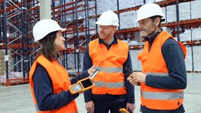Warehouse workers are discussing logistics, using handheld devices for efficient inventory management - Powered by Shutterstock - Get 15% off with code: PIKWIZARD15