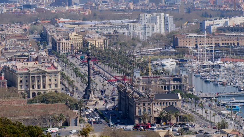 Hazy Barcelona cityscape panorama featuring the prominent landmark and distant mountains.	