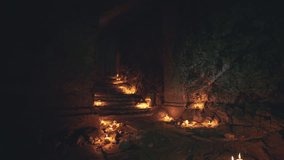 A dimly lit corridor reveals an old staircase with flickering candles lining the steps, creating a warm and mysterious ambiance. The flickering lights cast shadows on the stone walls. - Powered by Shutterstock - Get 15% off with code: PIKWIZARD15