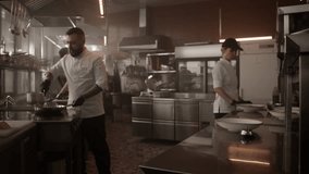 Man chef transferring cooked pasta from saucepan to plate - Powered by Shutterstock - Get 15% off with code: PIKWIZARD15