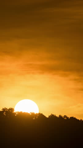 Breathtaking beauty of the sun rising time lapse video over a rugged mountain ridge on a cloudy morning.