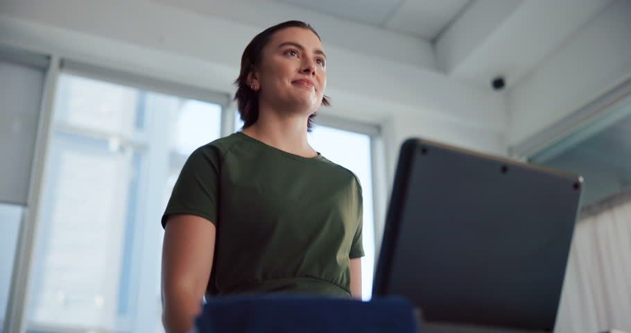 Workout, woman and walking on treadmill in home for cardio exercise, fitness challenge and burning calories. Low angle, athlete and smile on machine for weight loss progress, healthy body or training