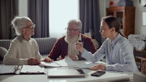 Female financial consultant reviewing documents with elderly couple, explaining savings plan and providing professional advice during meeting at home - Powered by Shutterstock - Get 15% off with code: PIKWIZARD15
