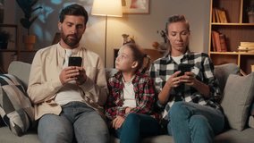 Caucasian family parents mother father using mobile phone smartphones scrolling gadgets addict dependence internet ignore daughter child sad kid girl ask attention lonely problem at evening home night - Powered by Shutterstock - Get 15% off with code: PIKWIZARD15