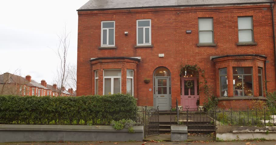 Beautiful red brick townhouse in Dublin, Ireland, featuring unique doors and a cozy atmosphere