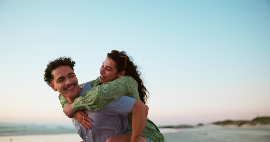 Sea, piggyback and couple on vacation, travel and exploration in nature for romance, people and together. Outdoor, tourist and playful on date at beach, man and woman in relationship on holiday