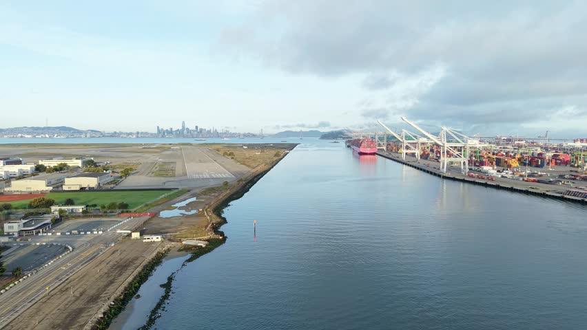 A zoom out aerial view of the Oakland Inner Harbor between the Port of Oakland and Alameda Point.
