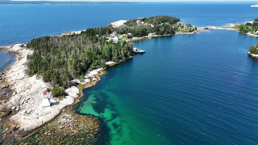 4K drone footage of houses and boats on the waterfront along the ocean in Nova Scotia, Canada.