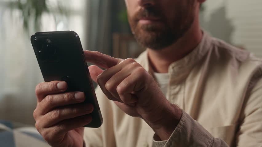 Cropped view man holding mobile phone hands scrolling touchscreen Caucasian guy male homeowner businessman touching display smartphone screen online shopping delivery buying gadget addicted at home