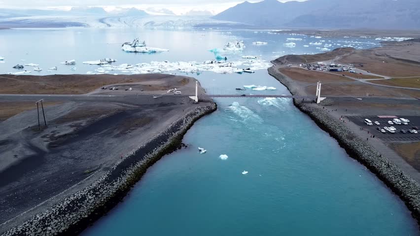 the aerial view of Fjollum river and ice pieces floating in river. The source of the river is the Vatnajokull glacier.