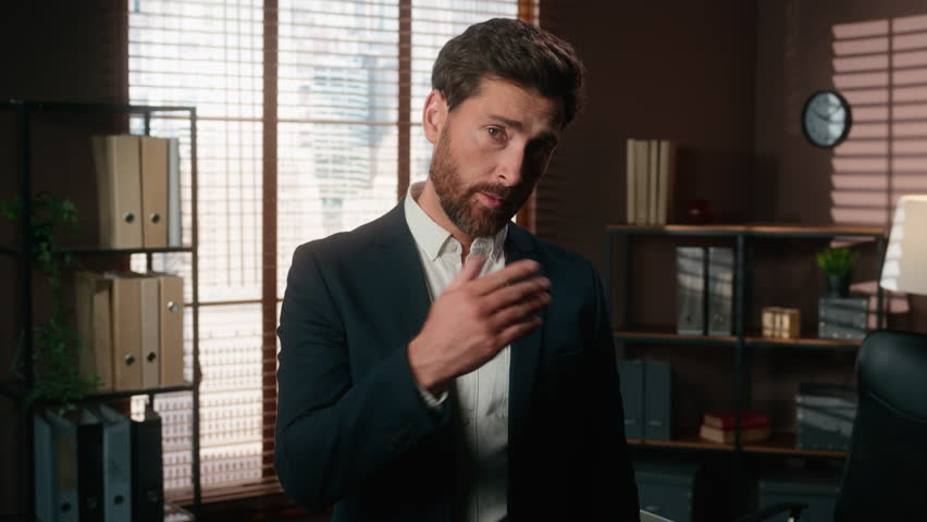 Confident Caucasian man male guy businessman business leader boss company CEO in office looking at camera pointing on wrist showing time like wristwatch late deadline invite come here welcome recruit