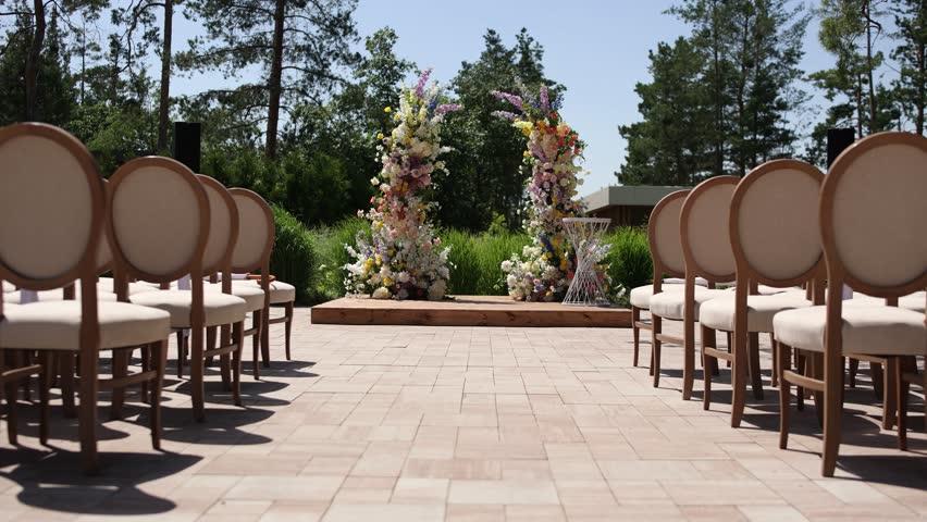beautiful arch for a wedding ceremony made of flowers with chairs