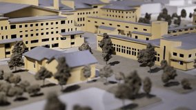 Architectural model of a residential complex featuring miniature buildings and trees - Powered by Shutterstock - Get 15% off with code: PIKWIZARD15