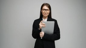 Confident woman in formal attire smiles, holding her laptop and radiating positivity.	
 - Powered by Shutterstock - Get 15% off with code: PIKWIZARD15