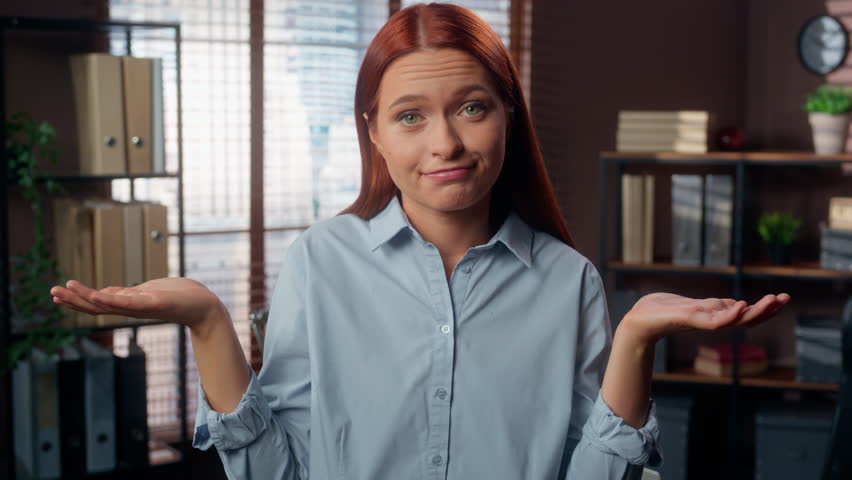 Caucasian woman business girl worker businesswoman looking at camera in office female dont know answer doubting shrugging shoulders spread palms unaware clueless has no idea answer work unsure doubt