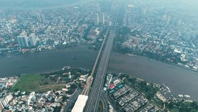 Aerial: Saigon Bridge during the day with fog, traffic, cityscape, and the Saigon River in Ho Chi Minh City, Vietnam, establishing drone shot - Powered by Shutterstock - Get 15% off with code: PIKWIZARD15