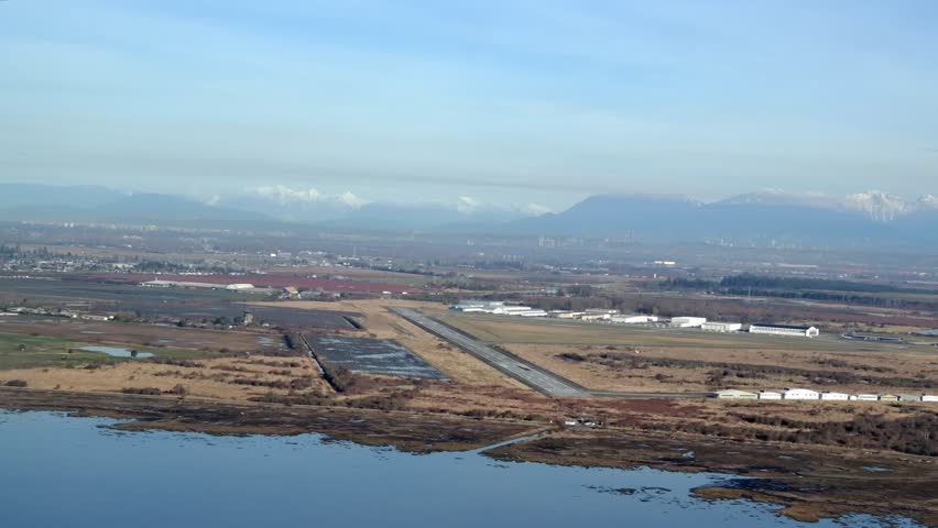 Aerial View of Boundary Bay Airport and Runway with Distant Mountains