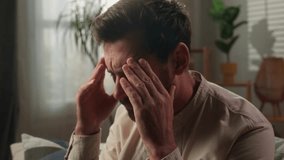 Sad frustrated Caucasian man sick male homeowner upset worried displeased guy on couch at home think problem crisis age suffer depression emotion stress health headache impotence mental psychological - Powered by Shutterstock - Get 15% off with code: PIKWIZARD15