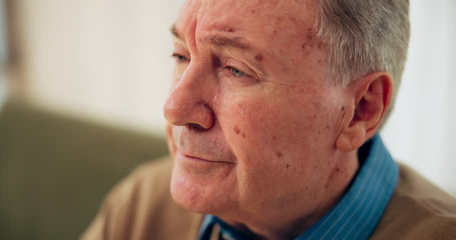 Home, senior man and thinking in retirement with depression, mental health and remember past memory. Sofa, male person and pensioner with anxiety for nostalgia, dementia and lonely in nursing house