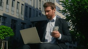 Happy rich carefree smiling wealth worker male employer with computer in city businessman business finance growth salary cash money holding counting banknotes man guy with laptop count financial prize - Powered by Shutterstock - Get 15% off with code: PIKWIZARD15