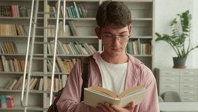 Caucasian teen man teenage male teenager guy boy student schoolboy pupil in bookstore bookshop client reading book read literature studying learning education in library school university college - Powered by Shutterstock - Get 15% off with code: PIKWIZARD15