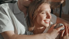 Gentle couple bonding home closeup. Affectionate lovers talking lying on couch in sunlight. Happy husband embracing smiling woman in modern cozy apartment. Cheerful sweethearts enjoying conversation. - Powered by Shutterstock - Get 15% off with code: PIKWIZARD15