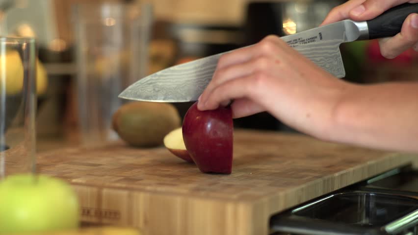 close up of female hands cutting red apple stock video