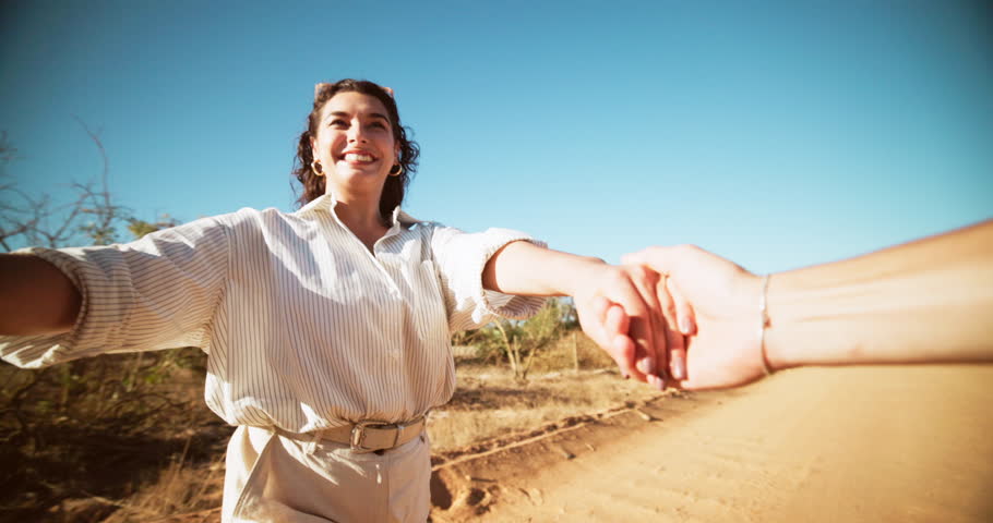 POV, holding hands and couple with love, countryside and bonding together with happiness. People, man and woman with relationship, spinning for anniversary and marriage with care, travel and smile