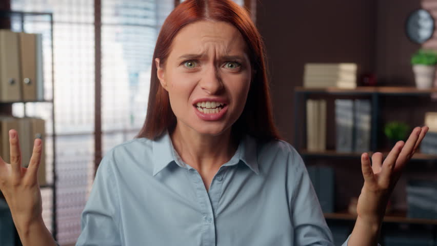 Portrait Caucasian girl angry furious rage mad aggressive business woman female worker businesswoman employer boss in office looking at camera yelling conflict scold argument anger talking screaming