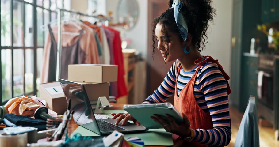 Woman, fashion designer and tablet in workshop with clothes, inspection or inventory check at small business. Person, digital touchscreen and app for collection, order or boxes for shipping at studio