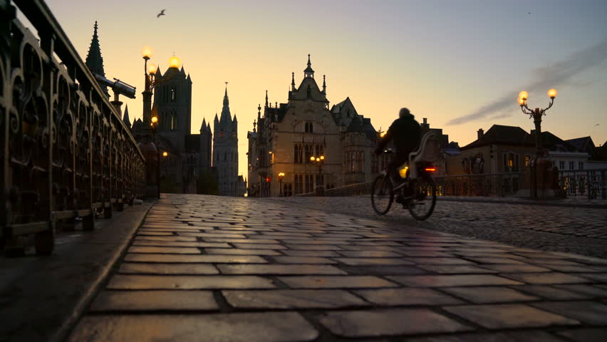 Dawn Bicycles St Michael’s Bridge Ghent Belgium 4K UHD. The view on Saint Michael’s Bridge to Nicholas church as bicycles cross at dawn. Ghent, Belgium. 4K, UHD.

