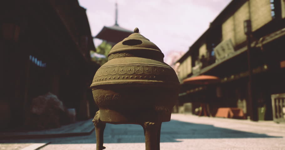 An intricately designed incense burner stands prominently in a serene, empty street. Surrounding structures feature classic architecture, enhancing the tranquil atmosphere of the day.