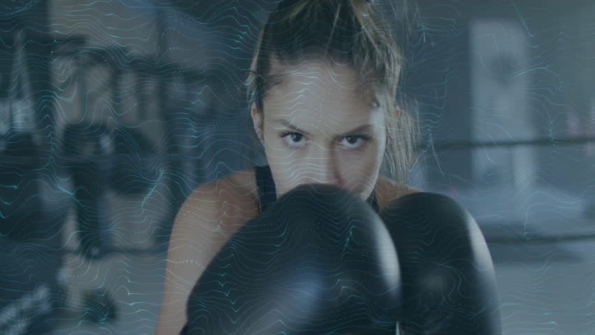 Boxing woman with digital wave animation overlaying scene in gym setting. Fitness, athletics, female athlete, virtual, technology, animated