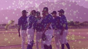 Baseball team huddling on field with colorful dot animation overlay. Sports, teamwork, unity, game, players, collaboration - Powered by Shutterstock - Get 15% off with code: PIKWIZARD15