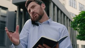 Serious male employer talking mobile phone call in city writing notes outdoors downtown write in notebook outside businessman business talk company negotiate man guy entrepreneur speaking smartphone - Powered by Shutterstock - Get 15% off with code: PIKWIZARD15